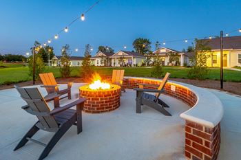an outdoor patio with a fire pit and chairs at Anthem Apartment Homes and Luxury Rentals in Huntsville, AL